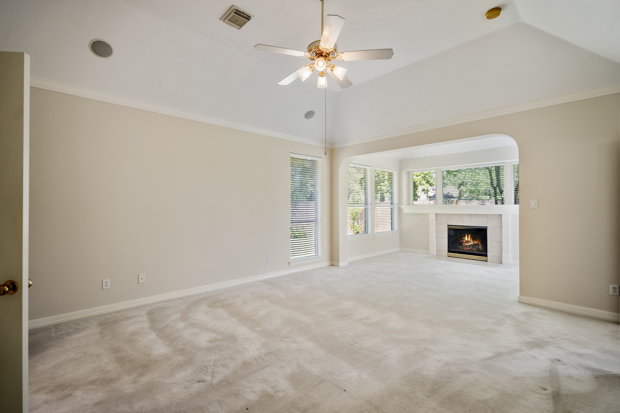 1322 Cardigan Bay Circle Spring, TX 77379 - Photo 23 of 50 Spacious primary suite offers; surround sound, a nice size sitting area that includes another gas log fireplace & wall of windows overlooking serene backyard.