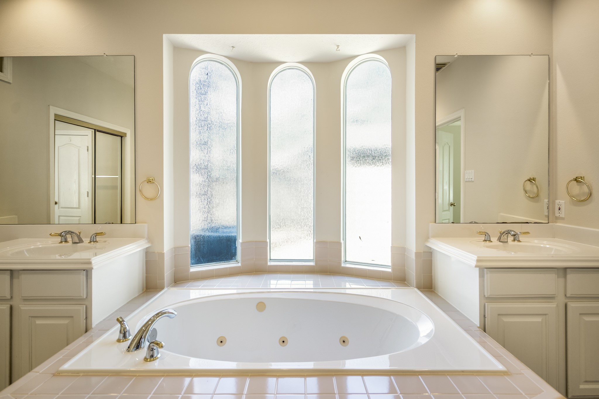 1322 Cardigan Bay Circle Spring, TX 77379 - Photo 27 of 50 Just behind the whirlpool tub is a beautiful triple-arched bay window, offering a frosted/texture for privacy while still allowing significant natural light into the room.