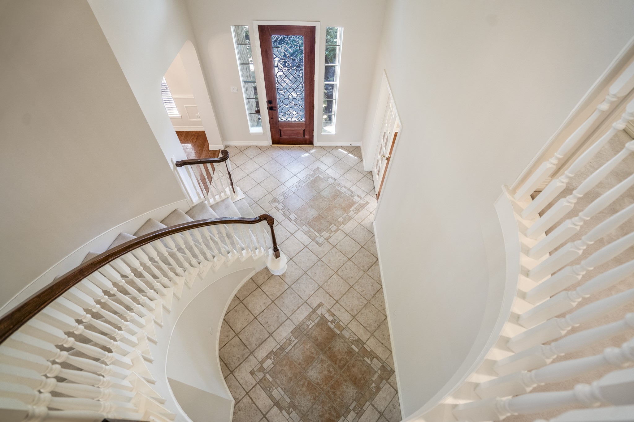 1322 Cardigan Bay Circle Spring, TX 77379 - Photo 28 of 50 The dramatic sweeping curved staircase features classic white spindles and wood handrail that provides a nice contrast to the light-colored walls.