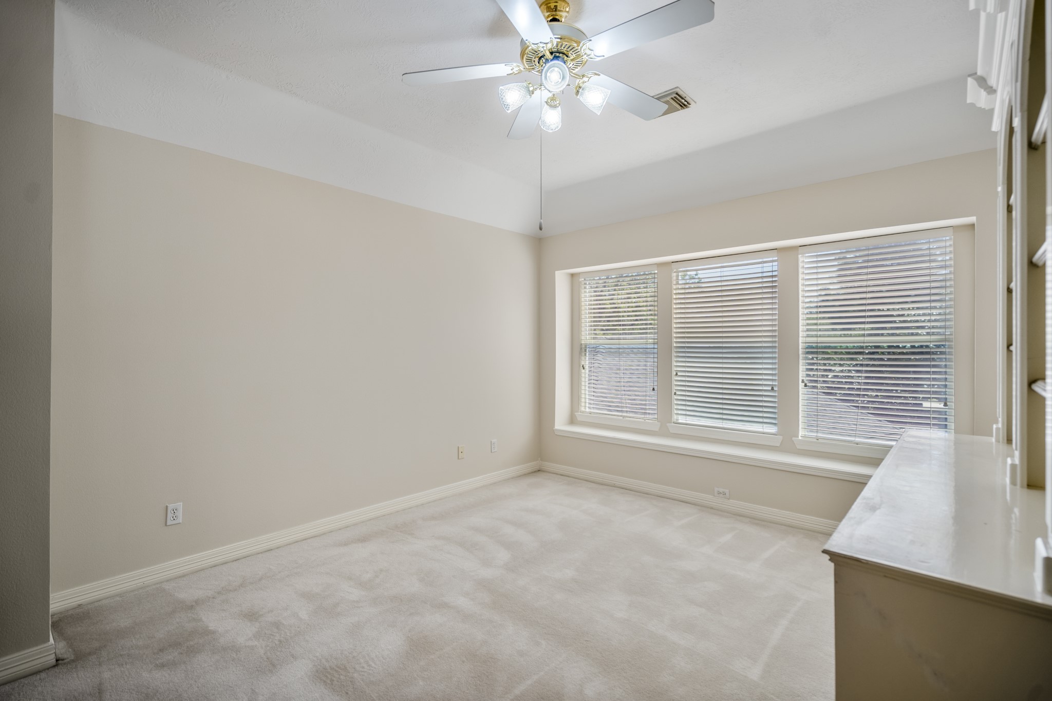 1322 Cardigan Bay Circle Spring, TX 77379 - Photo 32 of 50 The second bedroom has three large windows, an angled ceiling, neutral tones, and nice size closet.