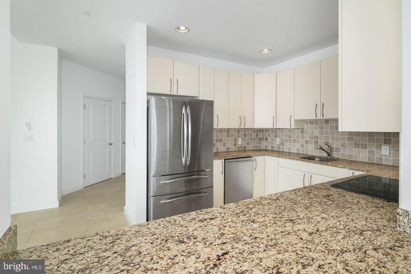 901 North Penn Street, Unit R1802 Philadelphia, PA 19123 - Photo 11 of 32 a kitchen with granite countertop a refrigerator and a sink
