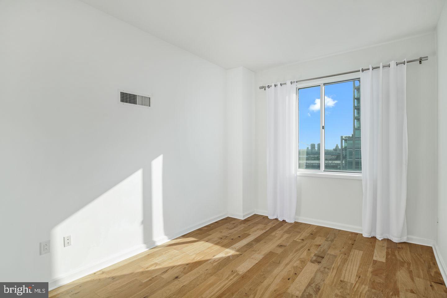 901 North Penn Street, Unit R1802 Philadelphia, PA 19123 - Photo 16 of 32 a view of a bedroom with a bedroom and a window