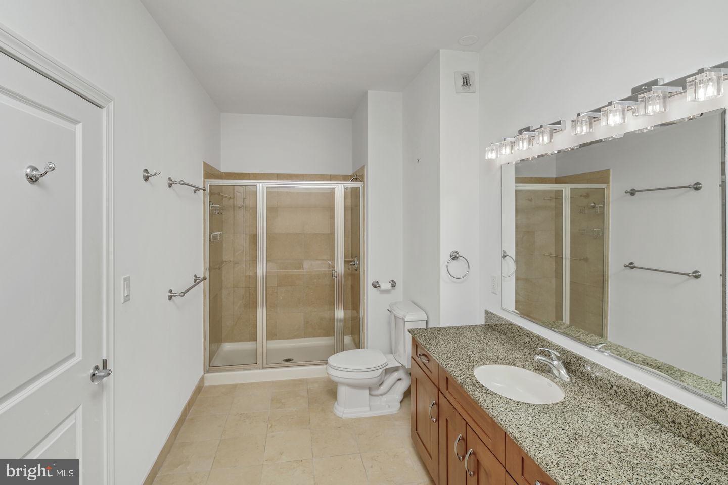 901 North Penn Street, Unit R1802 Philadelphia, PA 19123 - Photo 20 of 32 a spacious bathroom with a granite countertop sink a toilet and shower
