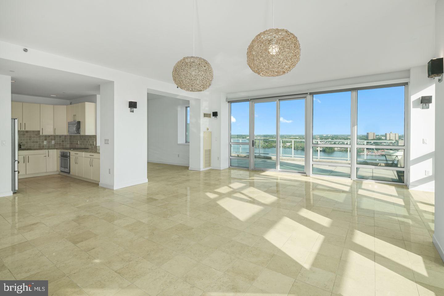 901 North Penn Street, Unit R1802 Philadelphia, PA 19123 - Photo 3 of 32 a view of an empty room with a fireplace and a large window
