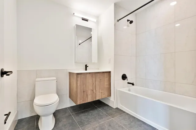 a bathroom with a toilet a sink and bathtub