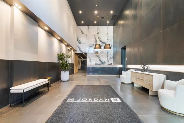 a lobby with furniture and stairs