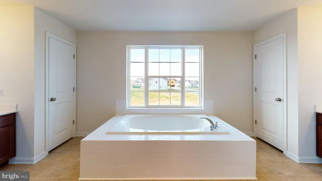 a view of bathroom with bathtub and window