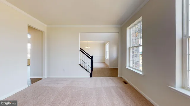 an empty room with windows and entrance