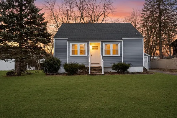 a front view of a house with a garden