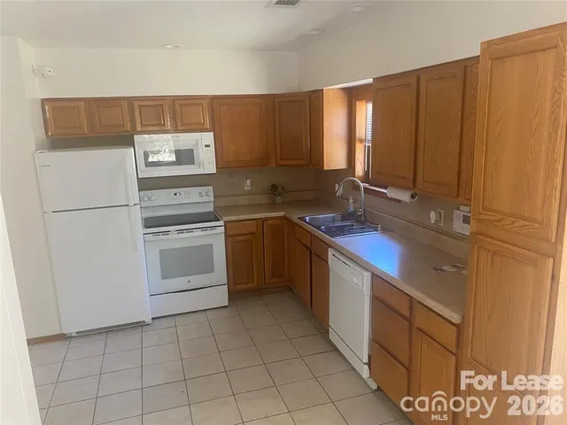 a kitchen with a sink cabinets and appliances
