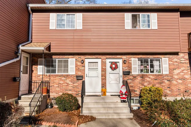 a view of a brick house with many windows