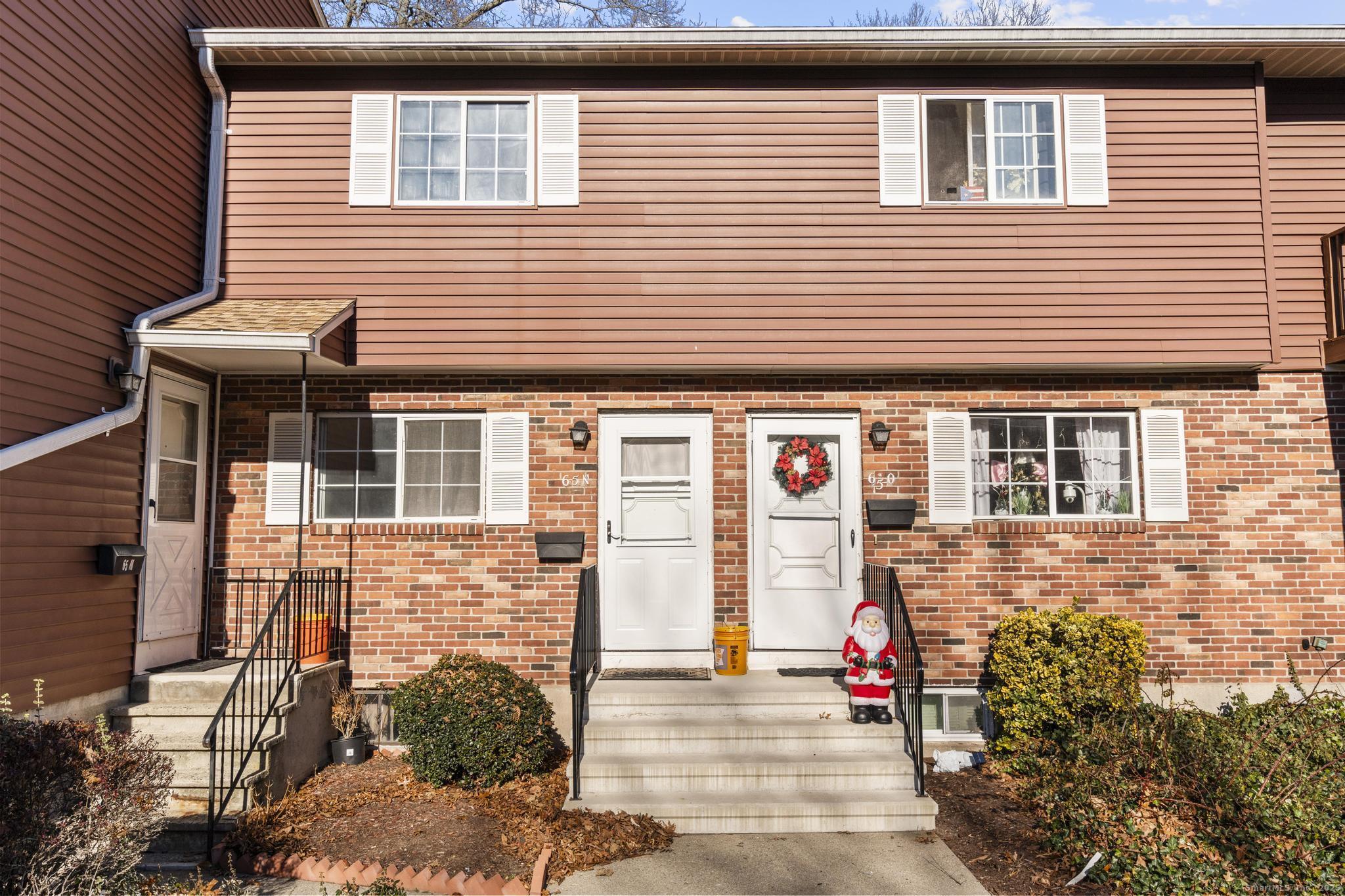 a view of a brick house with many windows