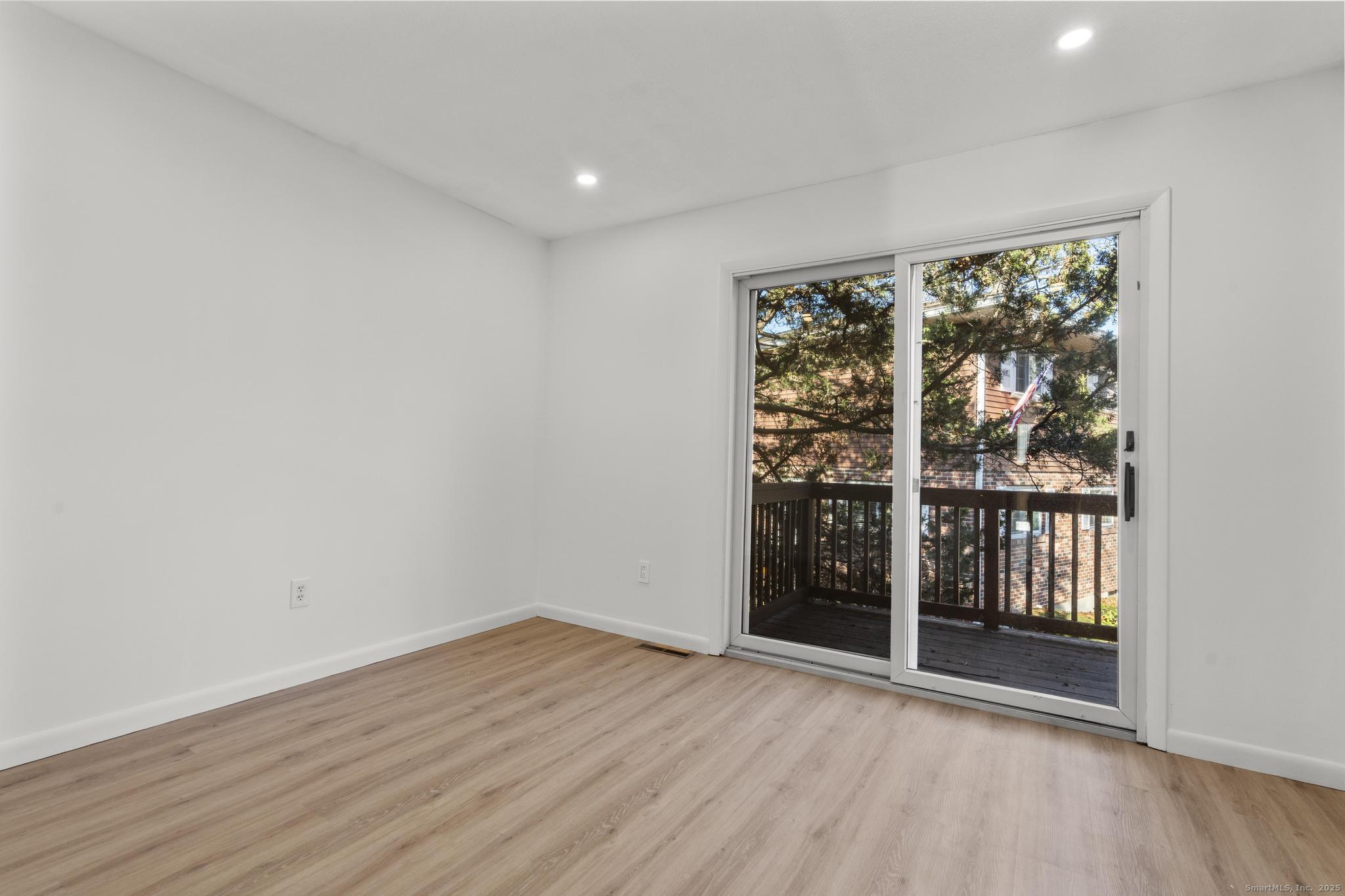 65 Patricia Road, Unit N Bridgeport, CT 06606 - Photo 11 of 25 wooden floor in an empty room with a window