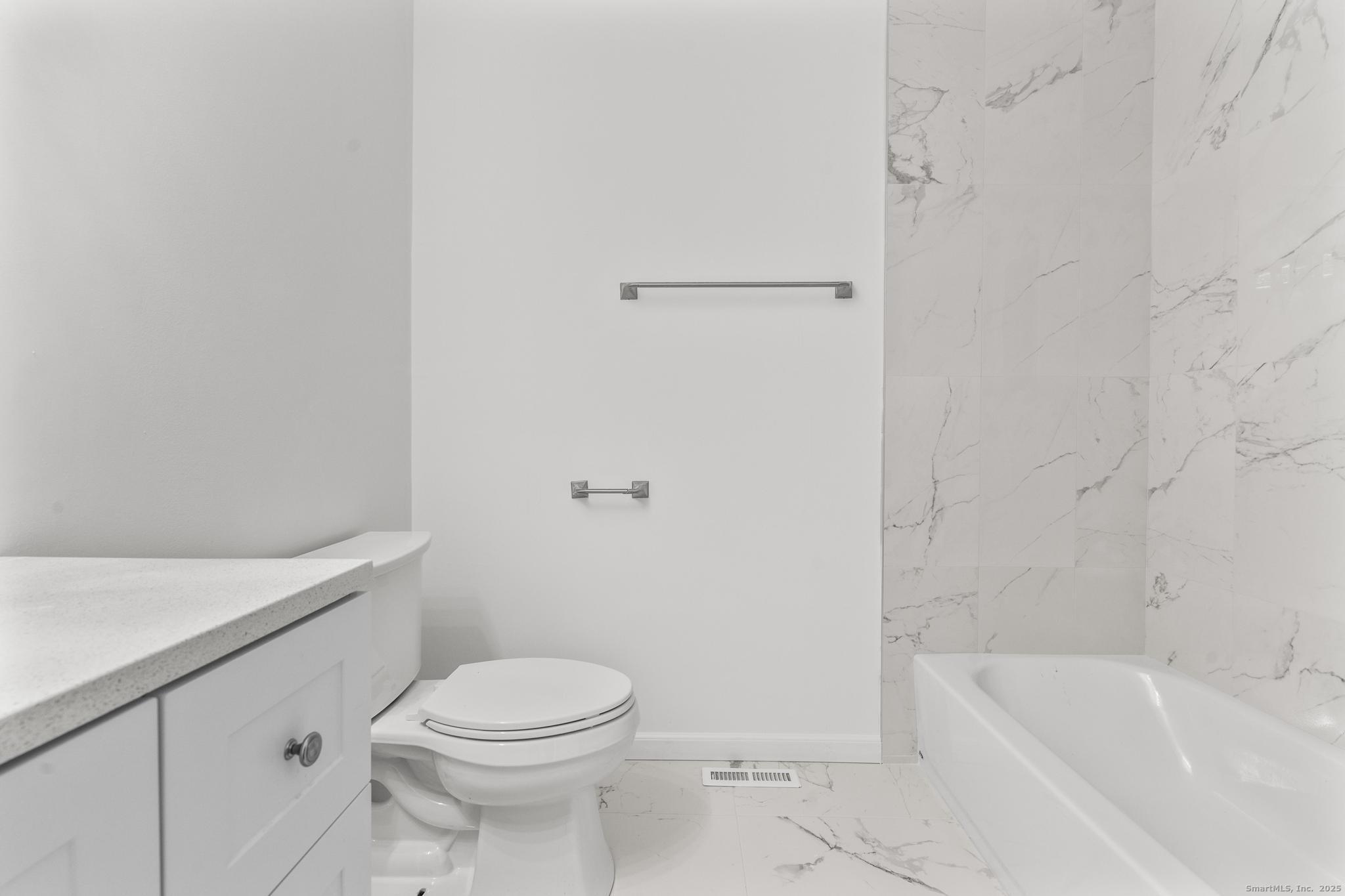 65 Patricia Road, Unit N Bridgeport, CT 06606 - Photo 17 of 25 a bathroom with a toilet and a bathtub