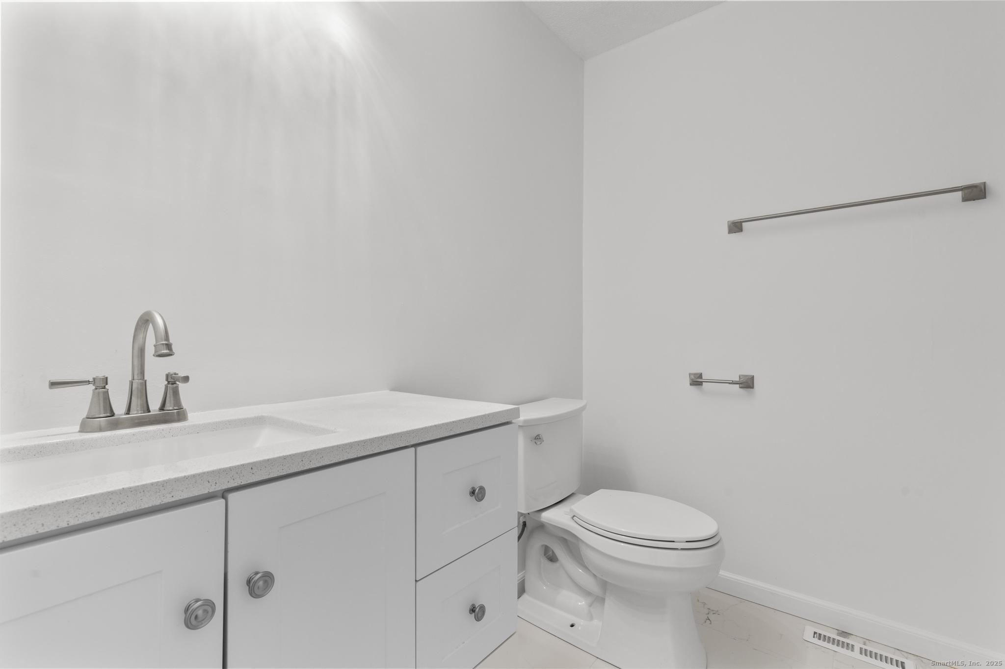 65 Patricia Road, Unit N Bridgeport, CT 06606 - Photo 18 of 25 a bathroom with a sink a toilet and a mirror