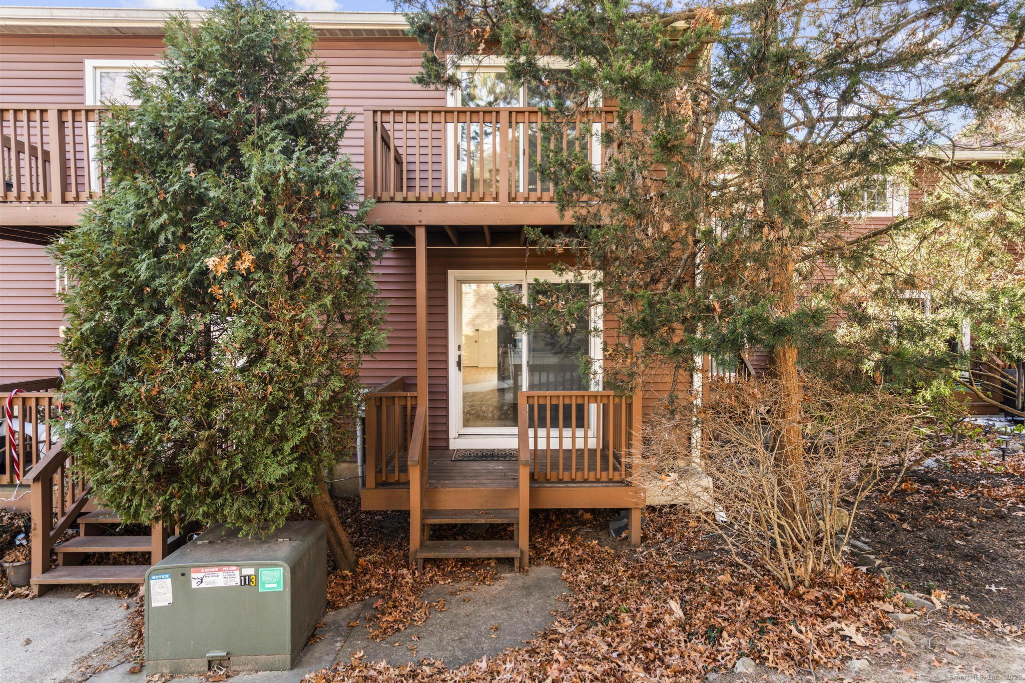 65 Patricia Road, Unit N Bridgeport, CT 06606 - Photo 20 of 25 a front view of a house with a yard and large tree