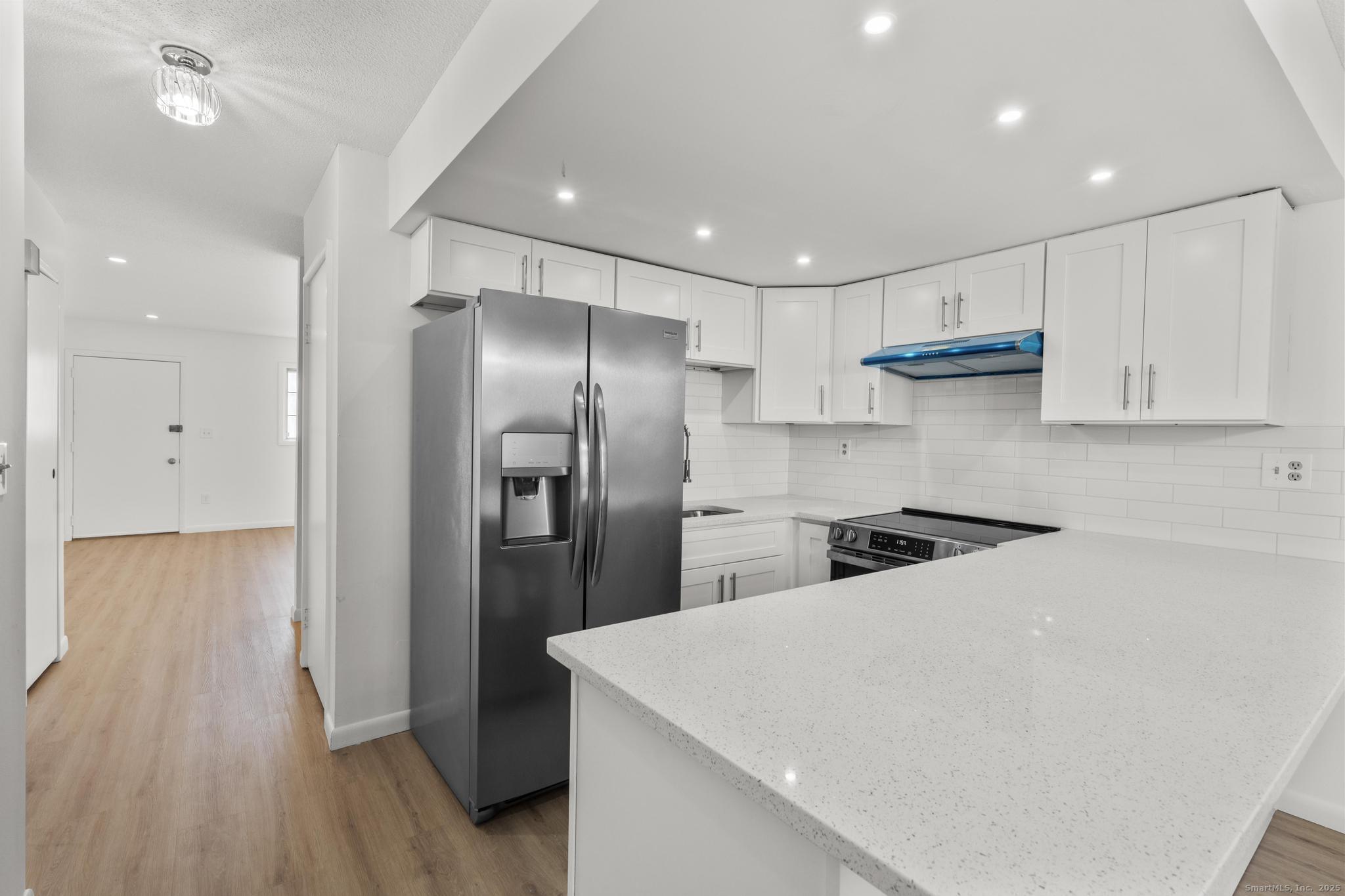 65 Patricia Road, Unit N Bridgeport, CT 06606 - Photo 3 of 25 a kitchen with stainless steel appliances a refrigerator and a stove top oven