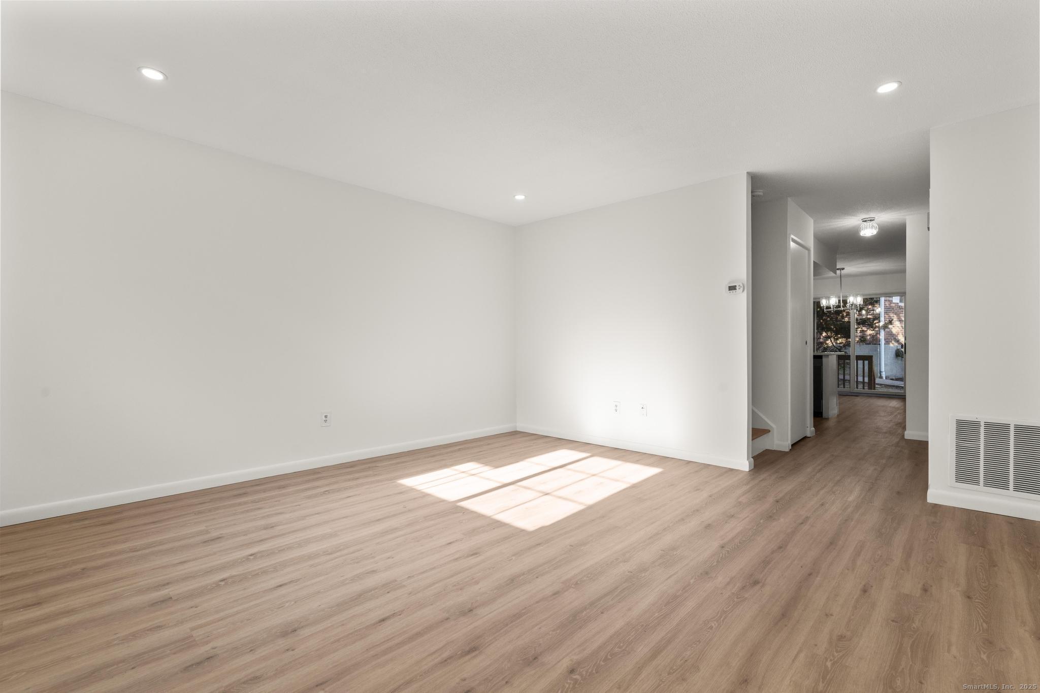 65 Patricia Road, Unit N Bridgeport, CT 06606 - Photo 10 of 25 a view of livingroom with hardwood floor and hallway