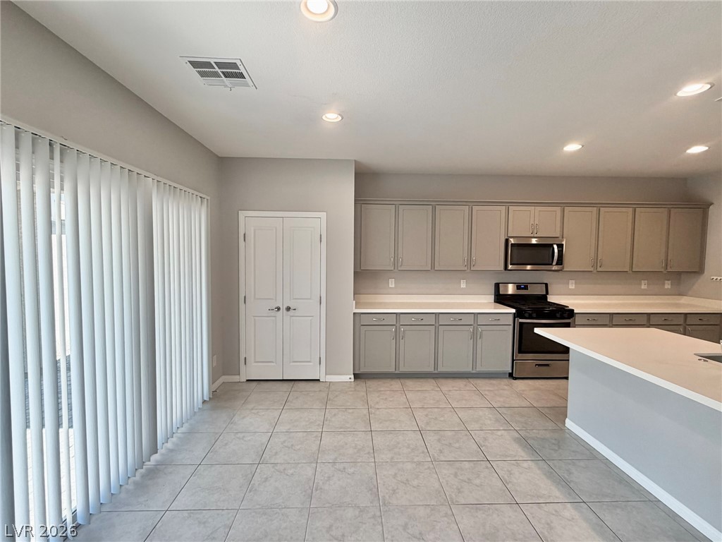 9953 Tucket Point Court Las Vegas, NV 89178 - Photo 8 of 22 A well-appointed kitchen features ample counter space and sleek appliances, connecting seamlessly with the living area.