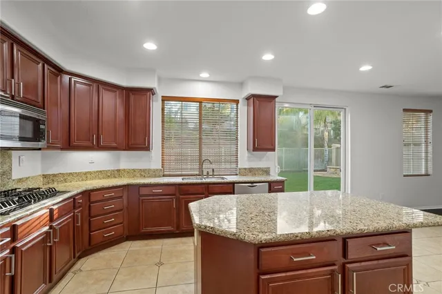 a kitchen with kitchen island sink and faucet