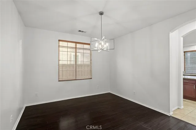 a view of an empty room with a window and a fan