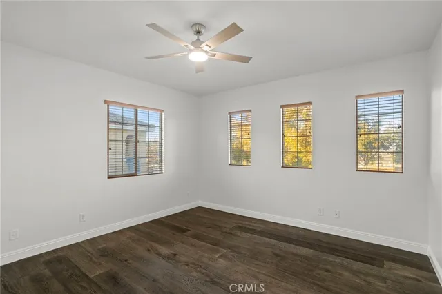 a view of a room with wooden floor and windows