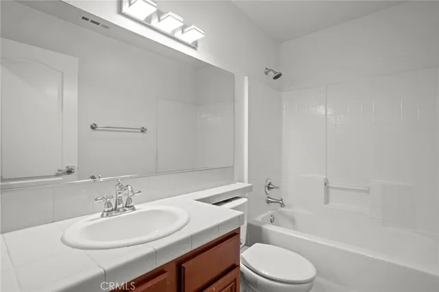 a bathroom with a sink double vanity and a mirror