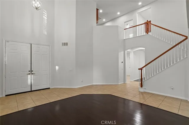a living room with hardwood flooring and a ceiling fan