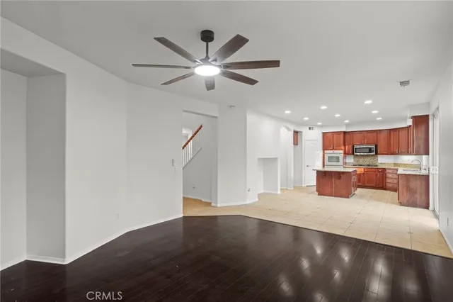 a open kitchen with stainless steel appliances granite countertop a refrigerator and a sink