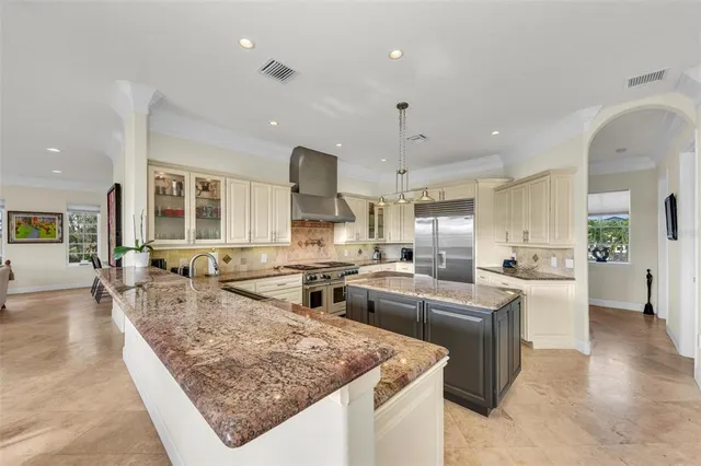a living room with furniture and kitchen view