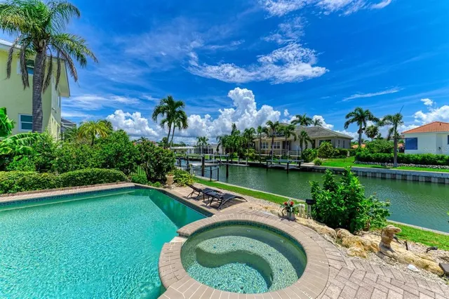 a kitchen with granite countertop a sink a counter top space stove and cabinets