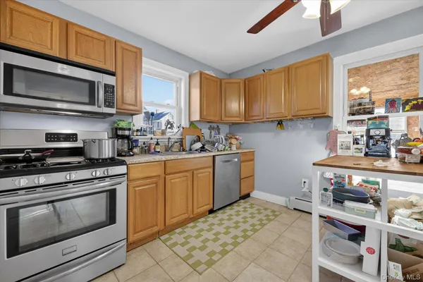 a kitchen with a stove a sink and a microwave