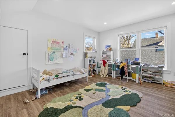 a bedroom with furniture and a window