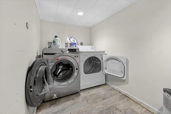 a utility room with sink dryer and washer