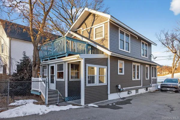 a front view of a house with parking space