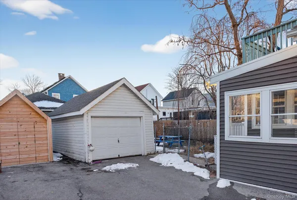 a view of a house with a yard and wooden fence