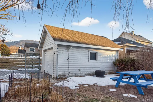 a view of house with backyard and outdoor seating