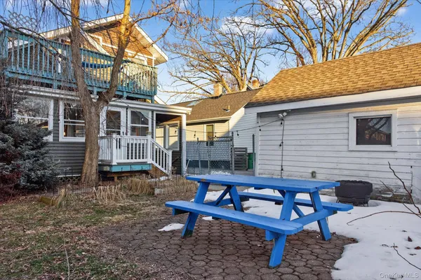 a backyard of a house with table and chairs