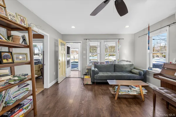 a living room with furniture and a book shelf