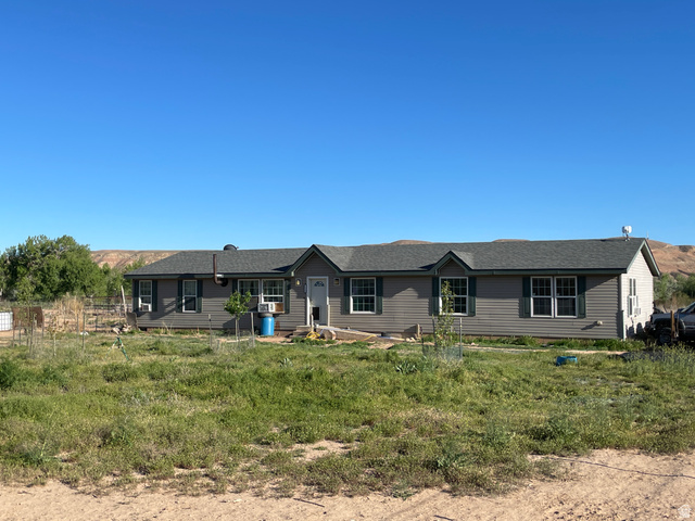 240 Horseshoe Bend Road Vernal, UT 84078 - Photo 2 of 41 Single-story residence featuring gray siding, a dark gray shingled roof, and white-framed windows with green shutters