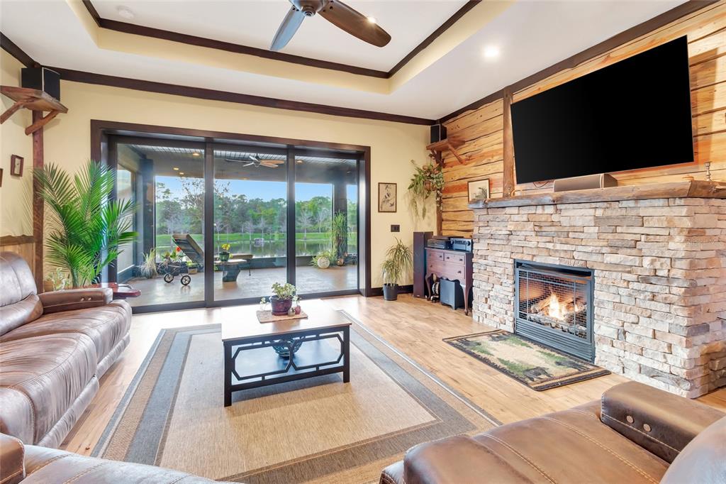 7330 Crabgrass Road St. Cloud, FL 34773 - Photo 13 of 60 a living room with fireplace furniture and a flat screen tv