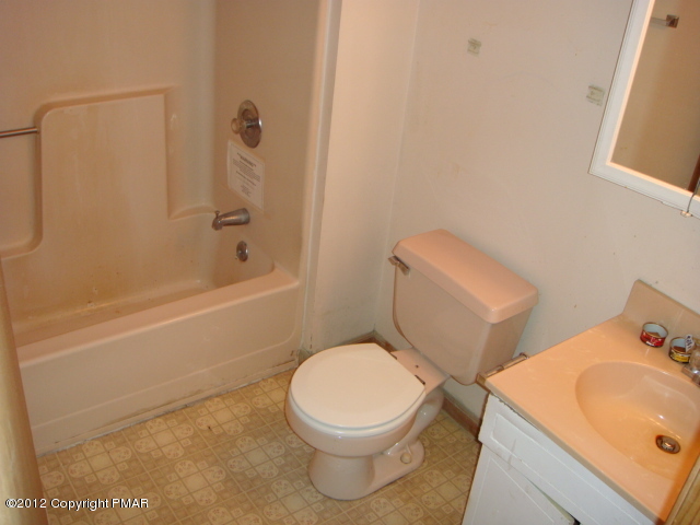 2384 Decker Road Bushkill, PA 18324 - Photo 4 of 10 a white toilet sitting next to a bath tub