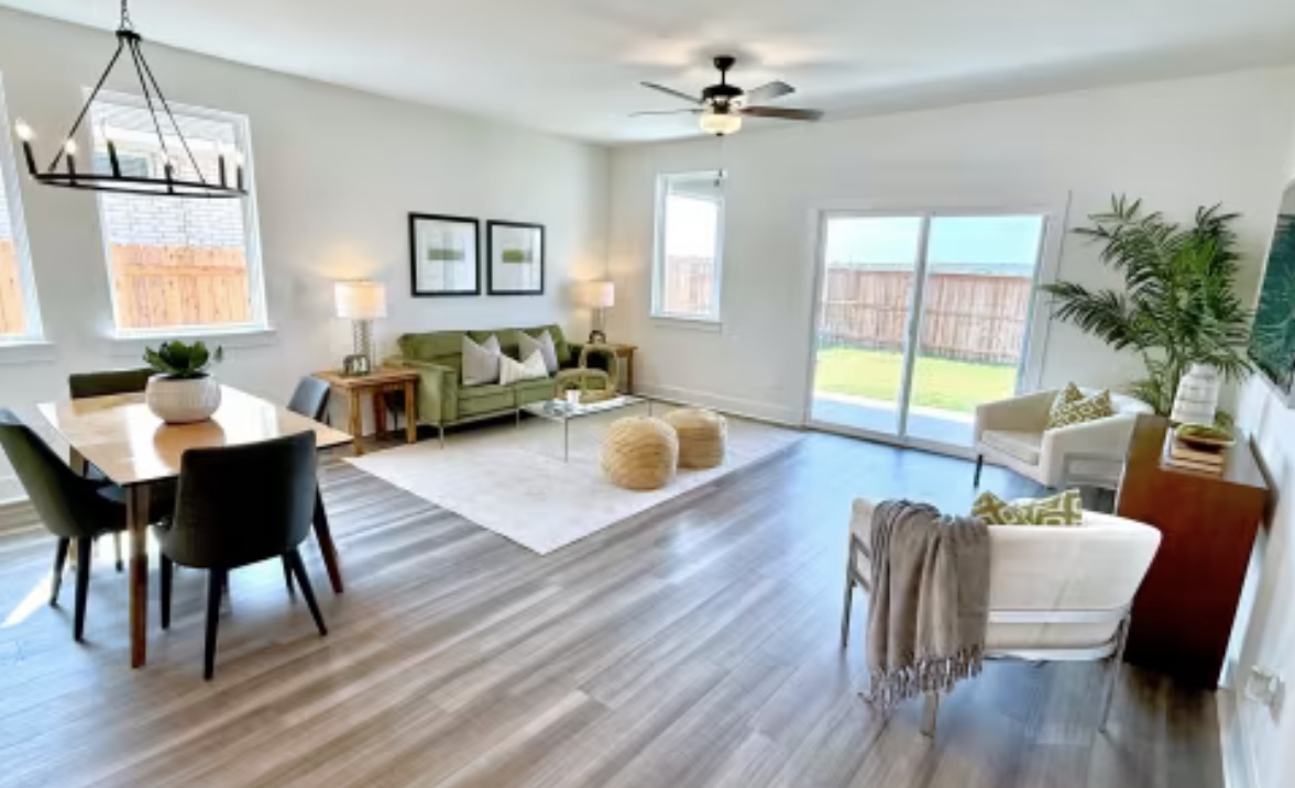 131 Sincere Drive Kyle, TX 78640 - Photo 4 of 15 a living room with furniture two window and a wooden floor