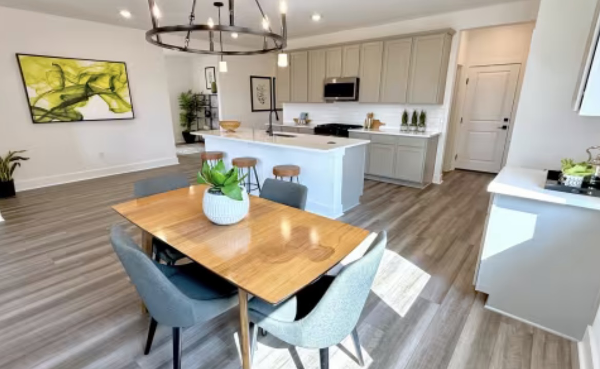 131 Sincere Drive Kyle, TX 78640 - Photo 6 of 15 a kitchen with stainless steel appliances a dining table chairs and kitchen view