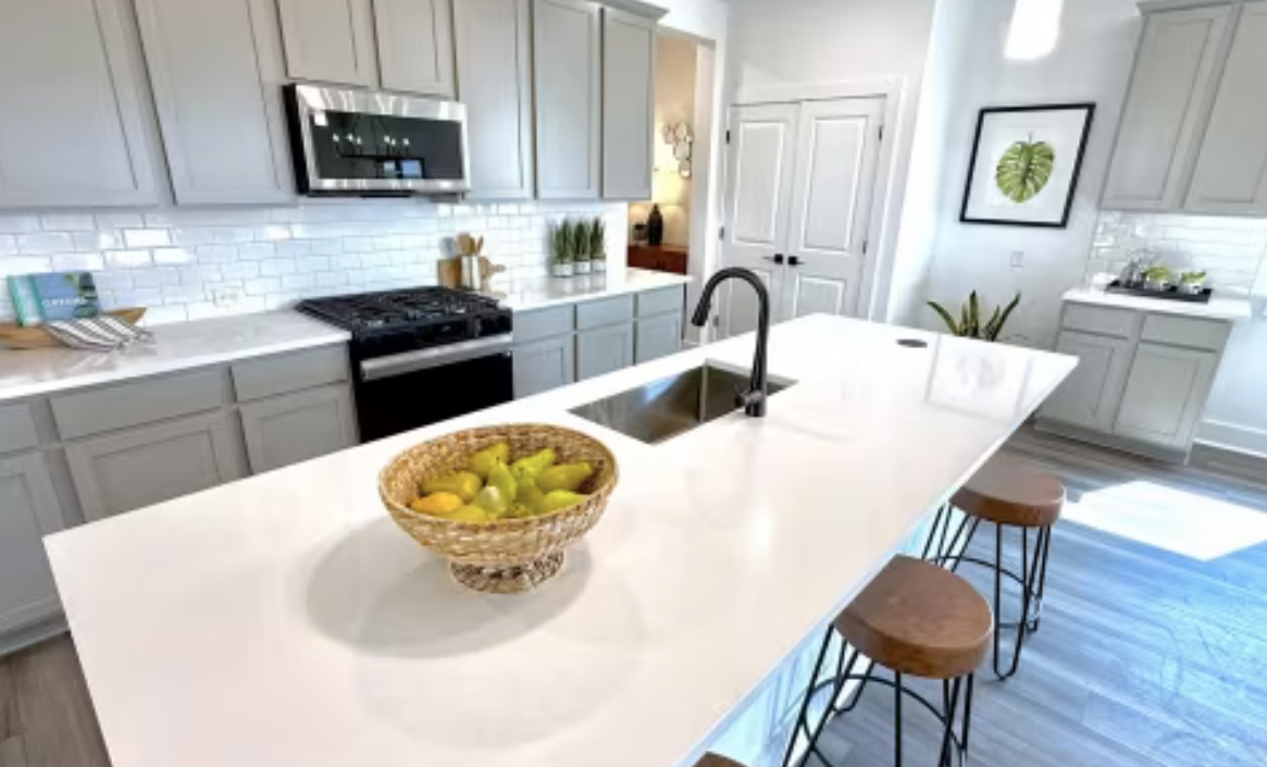 131 Sincere Drive Kyle, TX 78640 - Photo 7 of 15 a kitchen with a table chairs stove and microwave