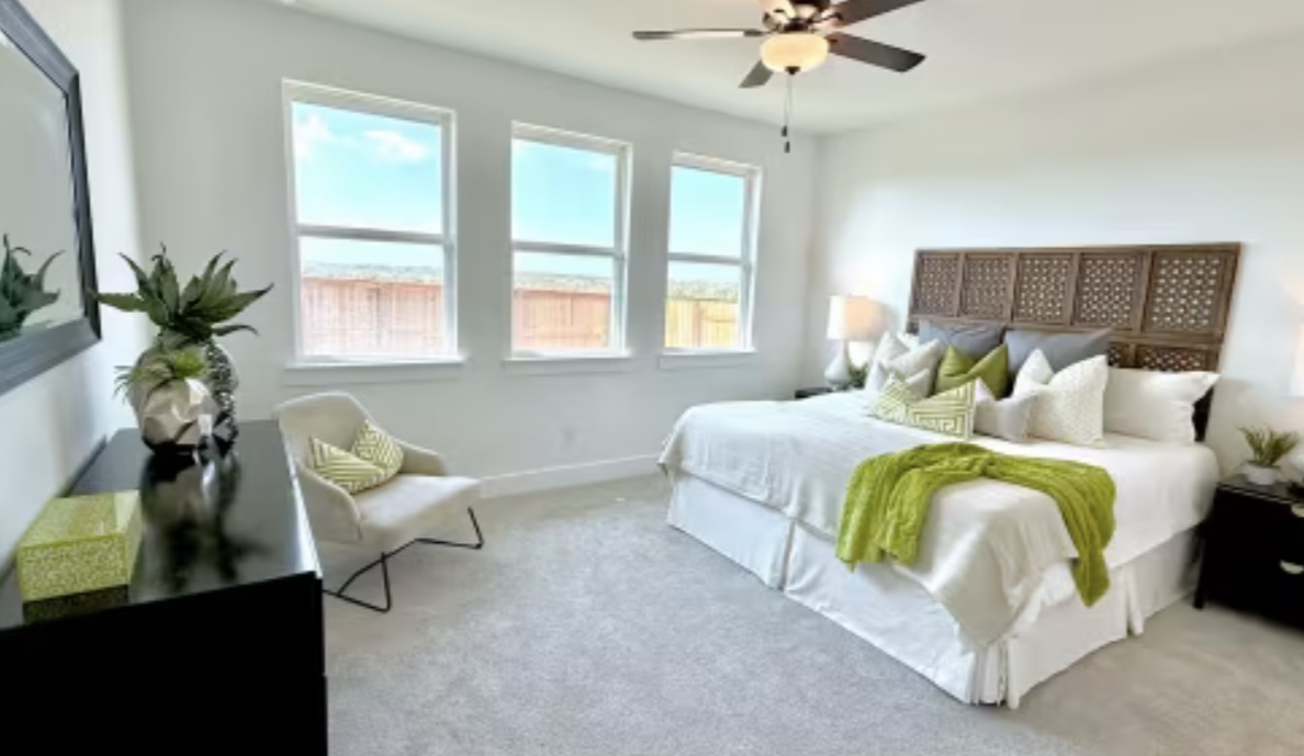 131 Sincere Drive Kyle, TX 78640 - Photo 10 of 15 a bedroom with a bed and a couch