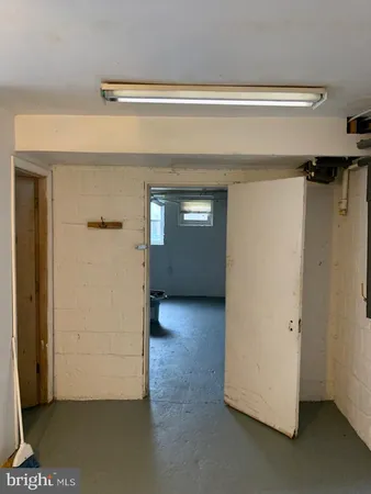 a view of walk in closet with clothes and window