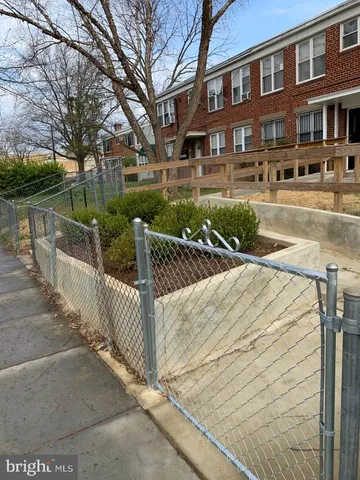 a street view with a building and trees in the background