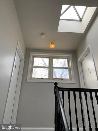 a view of a big room with wooden floor and brick walls