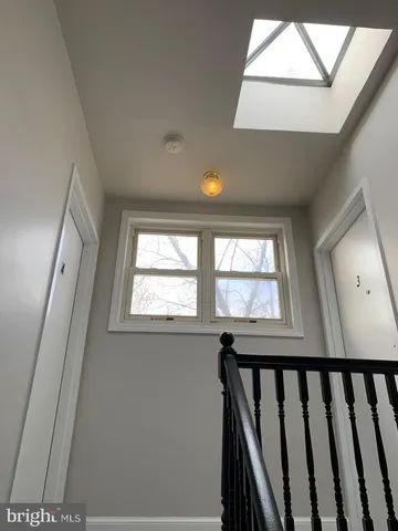 a view of a big room with wooden floor and brick walls